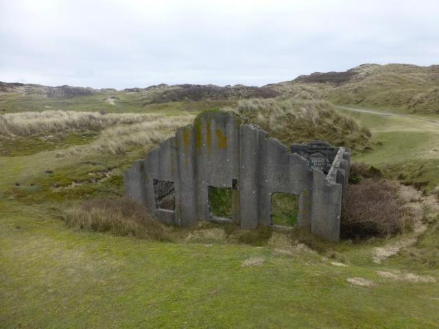 One of four surviving roofless structures thought to be the earliest known surviving group of mass-concrete magazines, dating to the 1890s.